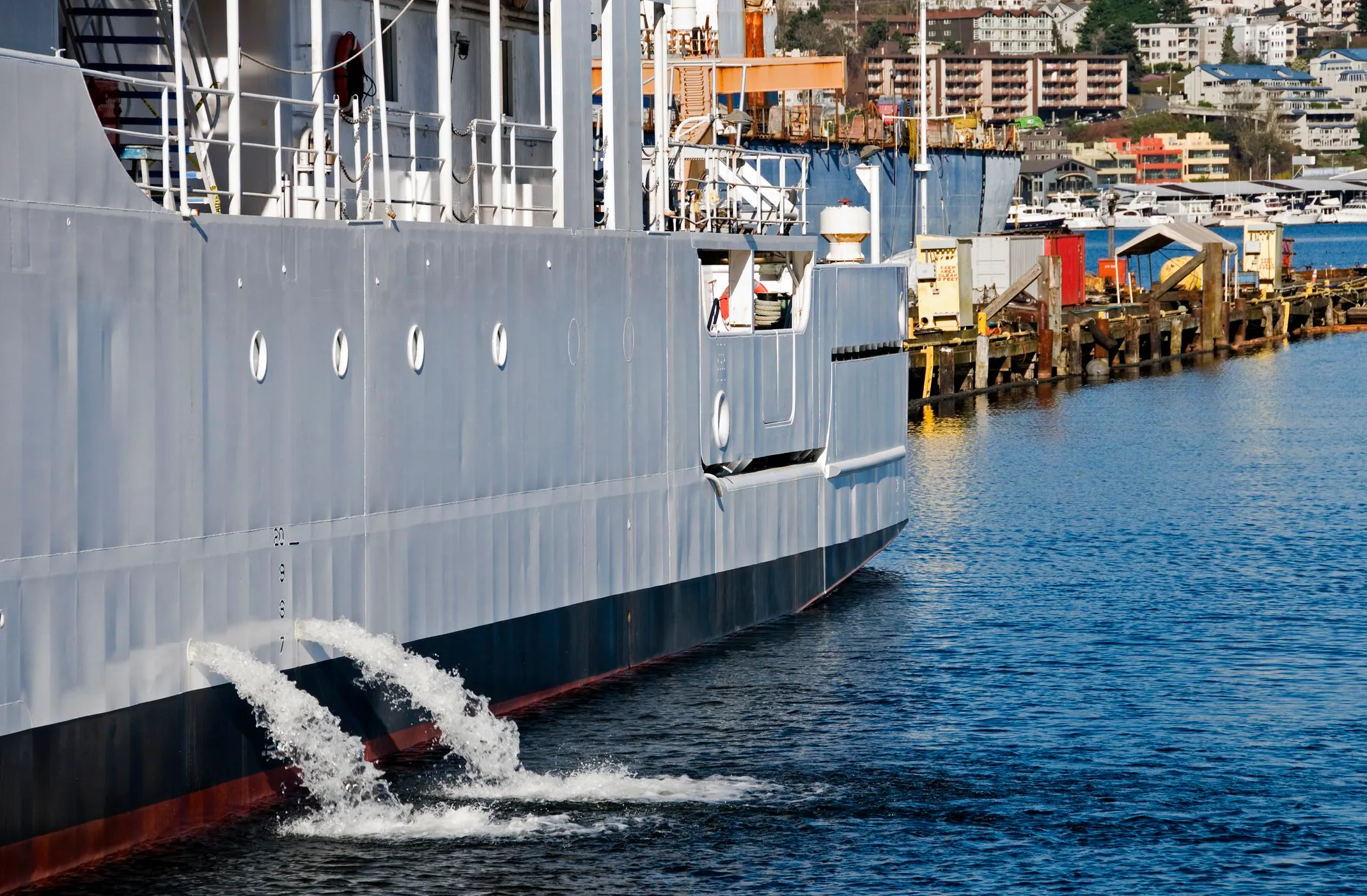 Ballast water pouring from the side of a ship